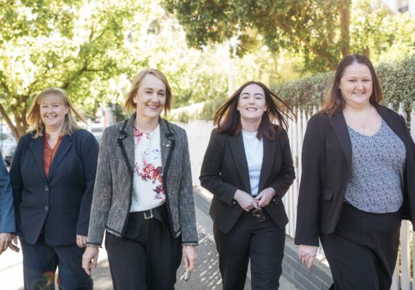 A group of lawyers walking and smiling.