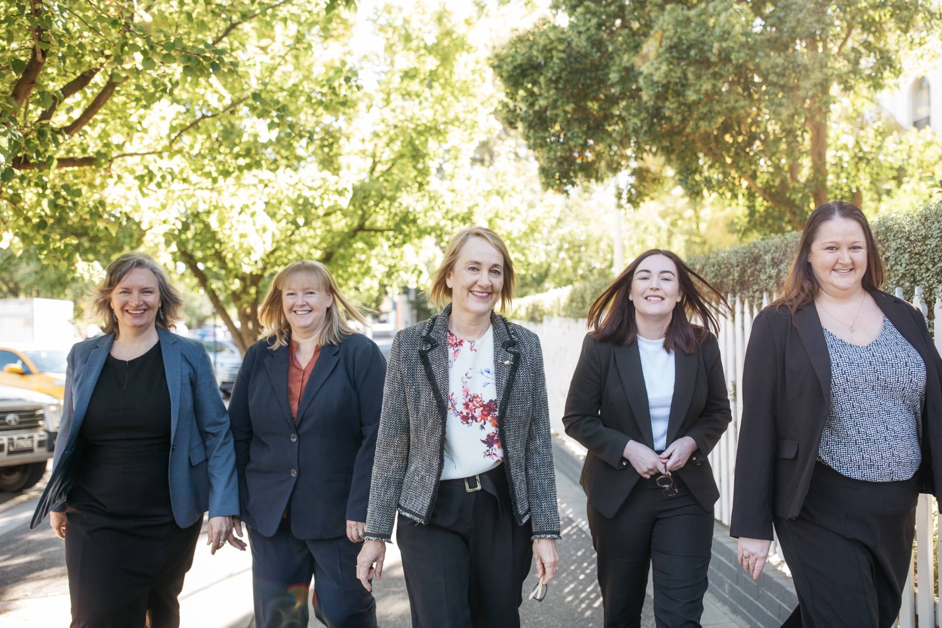 A group of lawyers walking and smiling.